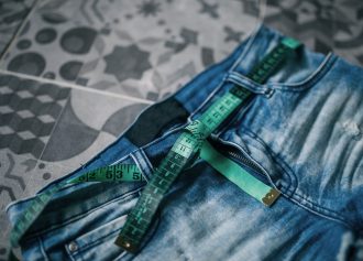 Measuring tape and jeans, weight loss concept